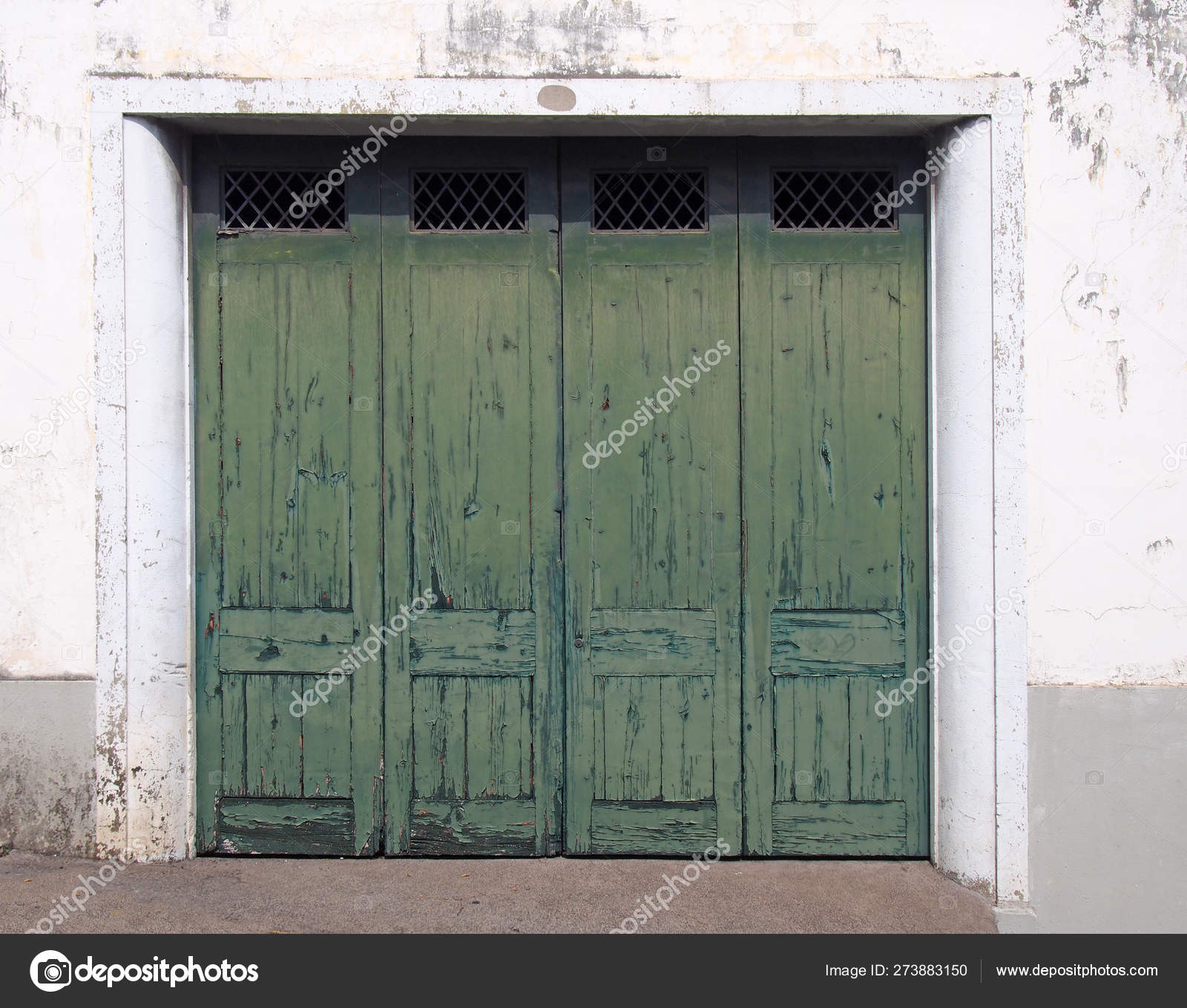 Four Paneled Old Wooden Paneled Exterior Doors With Green Fading