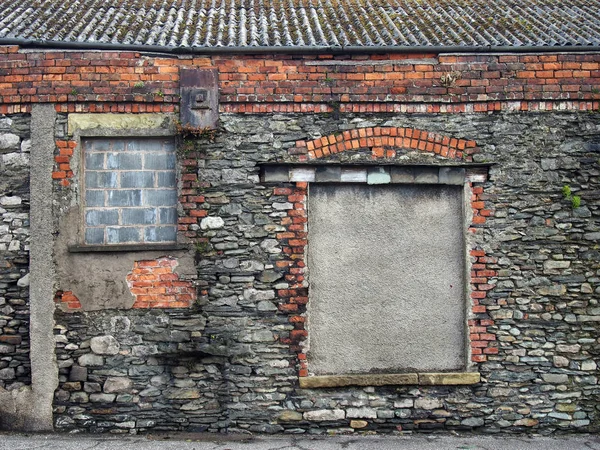 street view of picturesque deserted derelict house with crumbling repair