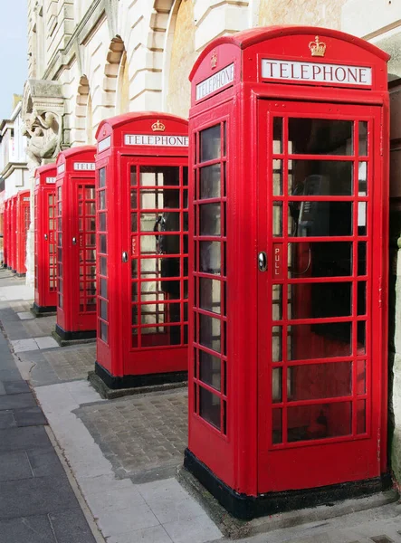 stock image a line of typical old fashioned british red public telephone boxes outside the former post office in Blackpool Lancashire