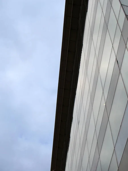 现代写字楼的垂直向上视图 一面是蓝色的云天 一面反映在窗户上 — 图库照片