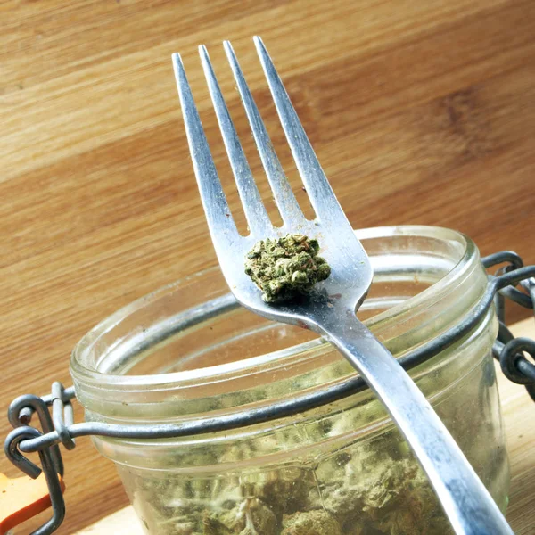 Close View Marijuana Glass Jar Metal Fork Wooden Background — Stock Photo, Image