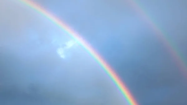 Blue sky with white clouds and rainbow