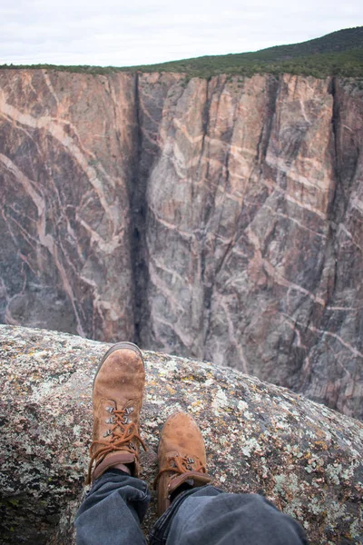 hiker legs against beautiful landscape view of rocky cliffs