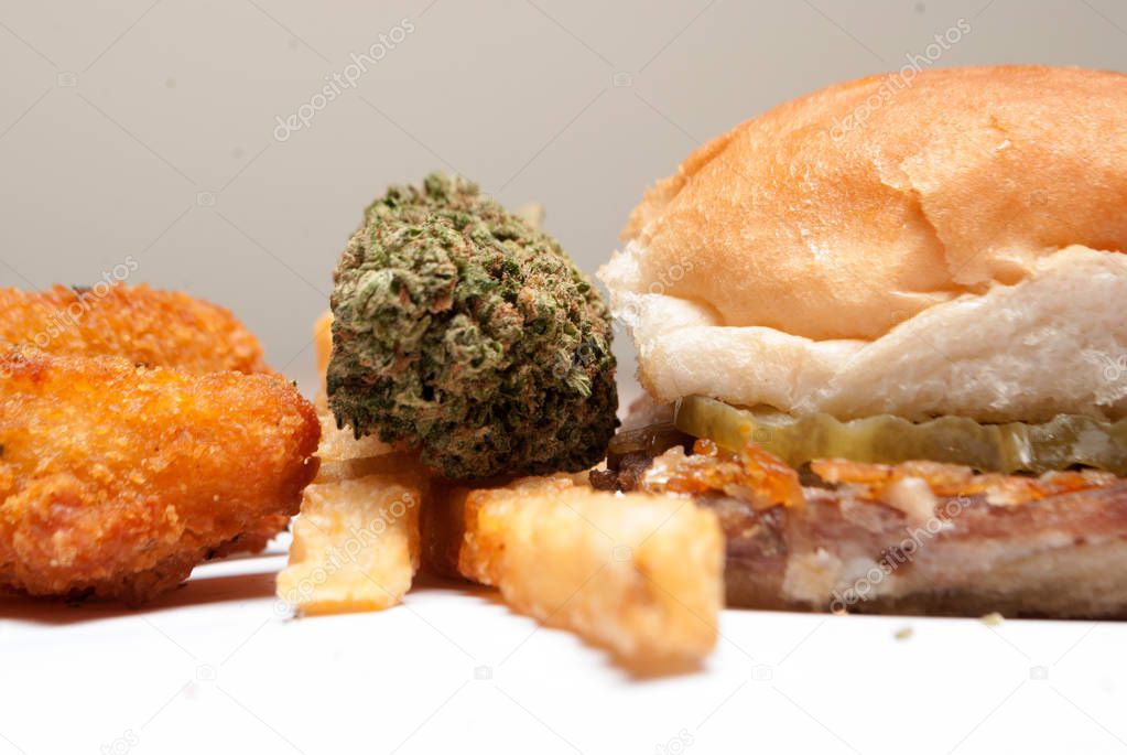 marijuana and cannabis munchies and unhealthy fried junk food on white background 