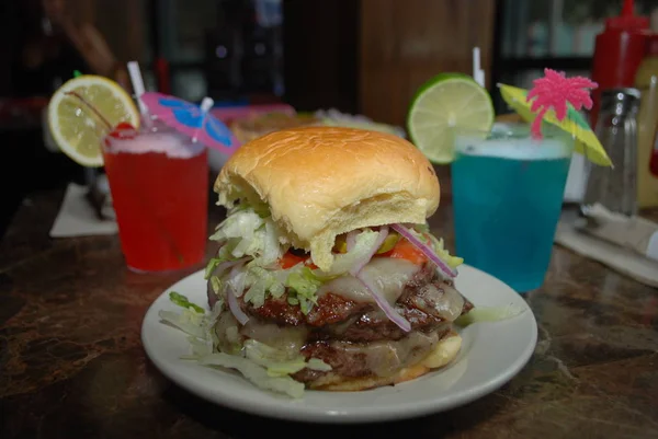 Cheeseburger with drinks, fast food.