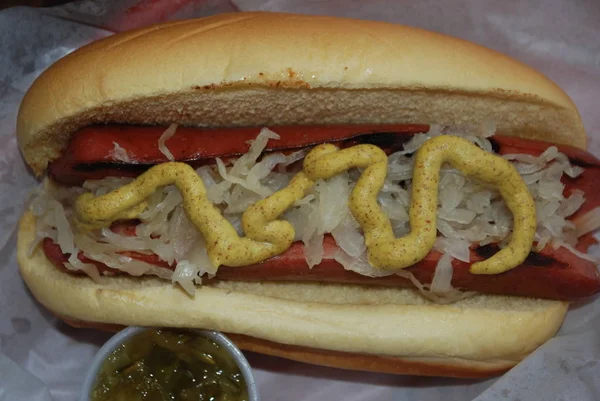 Hot-dog served with spicy sauce