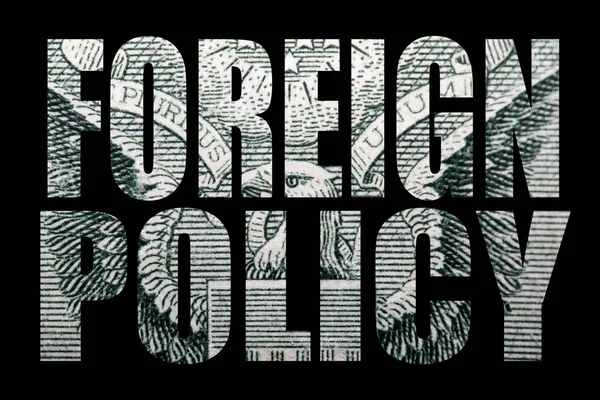 Foreign policy inscription with money inside on black background