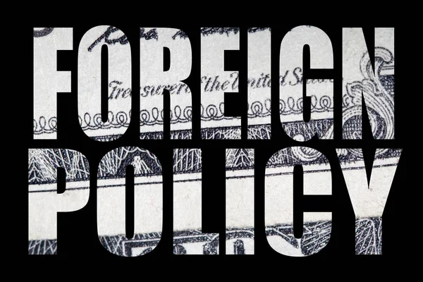 Foreign policy inscription with money inside on black background