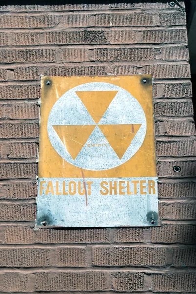Fallout shelter sign board on building wall