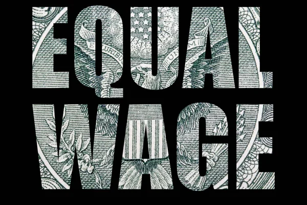 Equal wage lettering, money on black background.