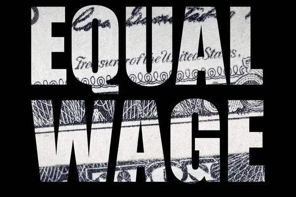 Equal wage lettering, money on black background.