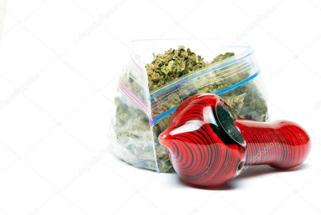 Marijuana and Cannabis Pipe and bag on background