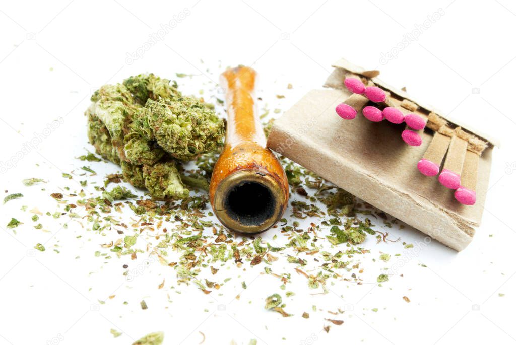 Marijuana and Cannabis Pipe on background