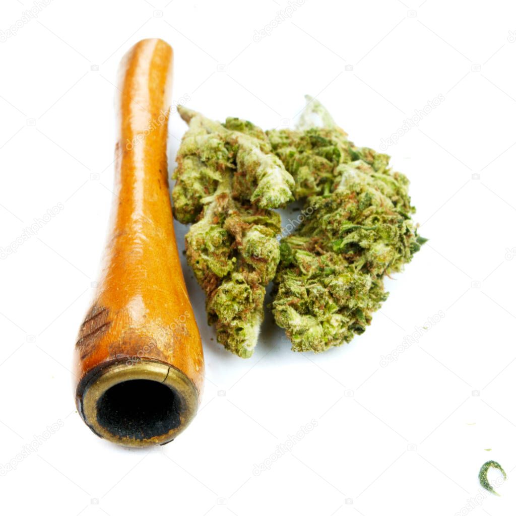 Marijuana and Cannabis Pipe on background