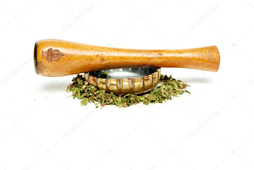 Marijuana and Cannabis Pipe on background