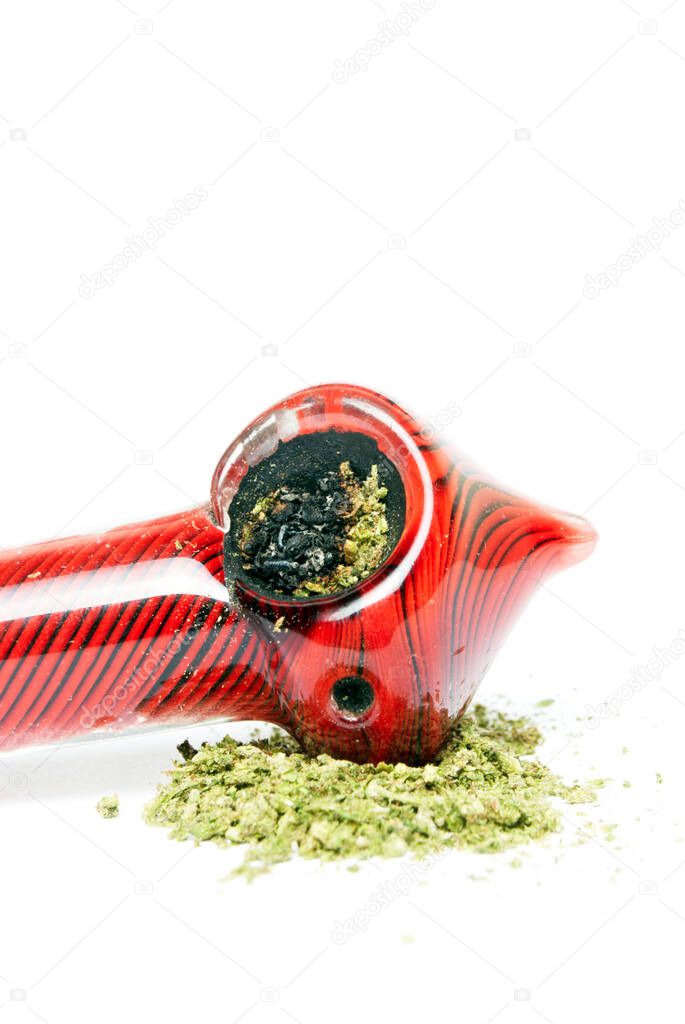 Marijuana and Cannabis Pipe on background
