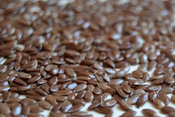 flax seeds, linen seeds on black background. healthy food. raw. vegan.