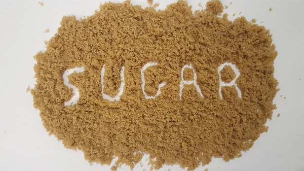 Sugar Spelled Out Brown Sugar White Background — Stock Photo, Image