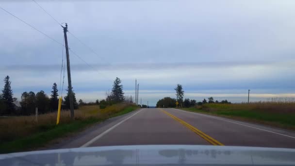 Vue arrière De L'arrière De La Voiture Conduisant La Route De Campagne Rurale Sous Le Jour Couvert. Point De Vue De Voiture POV Derrière Le Véhicule Country Street Sous Le Ciel Nuageux .