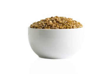 Bir fincan beyaz bir arka plan üzerinde izole kahverengi freekeh tahıl.