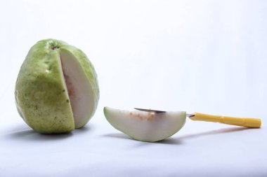 Küçük bıçak ve yalıtılmış beyaz arka planı olan taze beyaz guava parçaları.