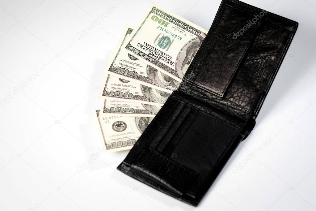 dollar bills in a black mens wallet on a white background and a passport of the Russian Federation
