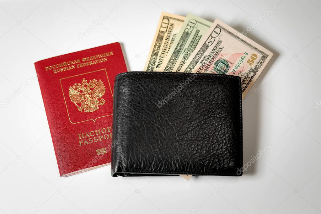 dollar bills in a black mens wallet and a passport of the Russian Federation