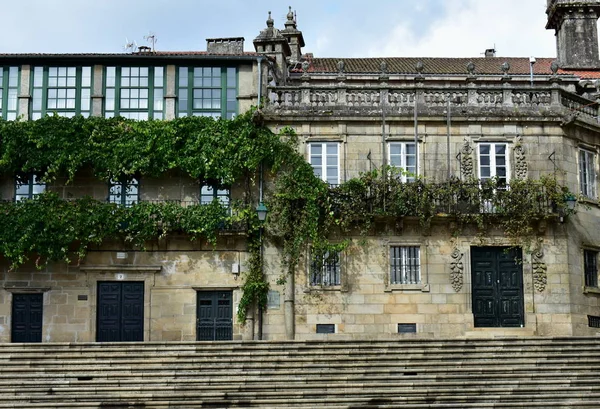 House with stone vine tree. Balcony with real vine tree in a black iron handrail. Quintana Square close to Cathedral, Santiago de Compostela, Spain.