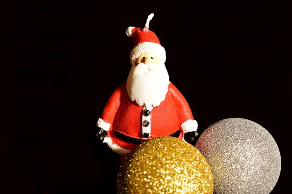 Christmas greeting card. Christmas decorations, balls and Santa Claus candle.