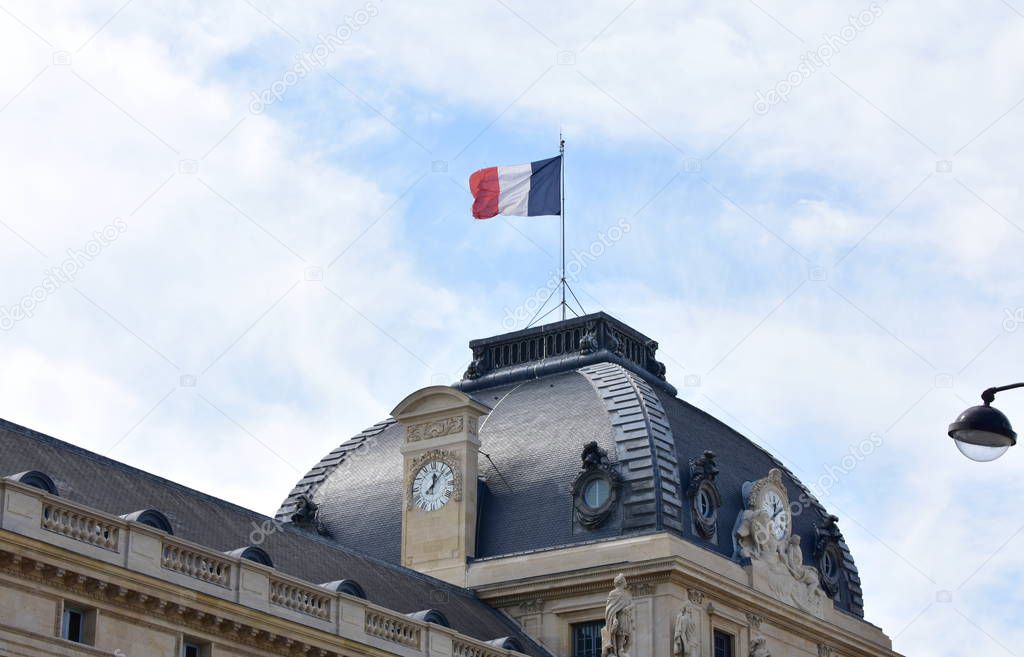 French flag on the top of the Ecole Militaire (Military School). Champ de Mars, Paris, France.