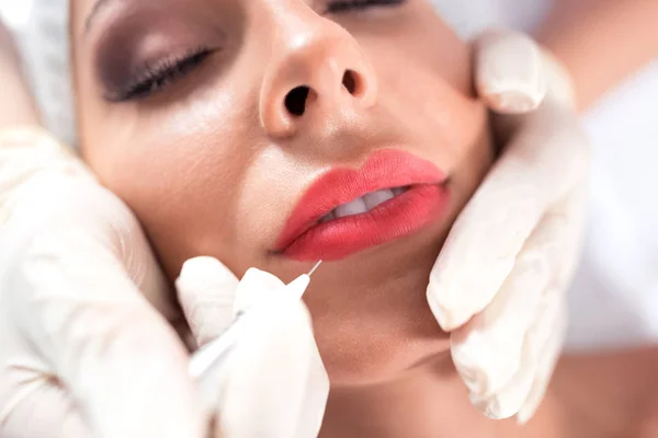 Microblading technique being applied for creating of kissable lips