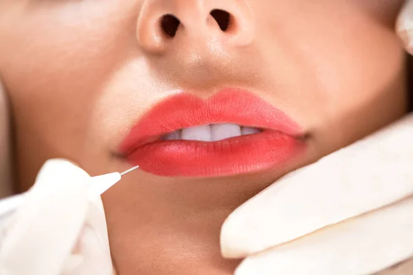 Lips enhancement technique with microblading applied to a beautiful woman