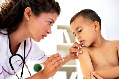 A boy taking a vaccine shot with no fear in his eyes  clipart