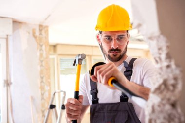 Manuel çalışma geçiş ücretleri ile yıpranmış bir duvar aşağı yırtılma