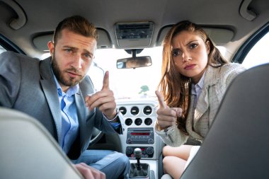 Mom and dad turning back and making angry faces as they are being upset by the behavior of their kids in the back seat clipart