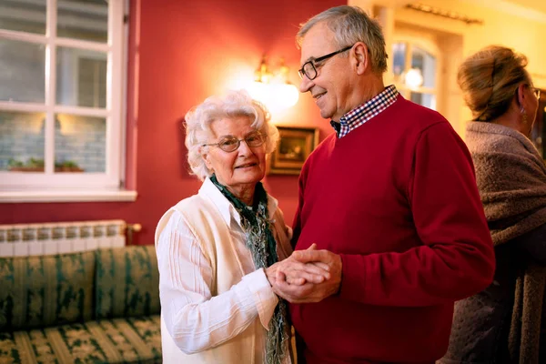 Older couple dancing in the room and enjoying their time together