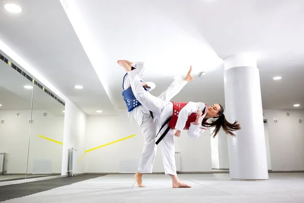 Exchange of high kicks during training of taekwondo