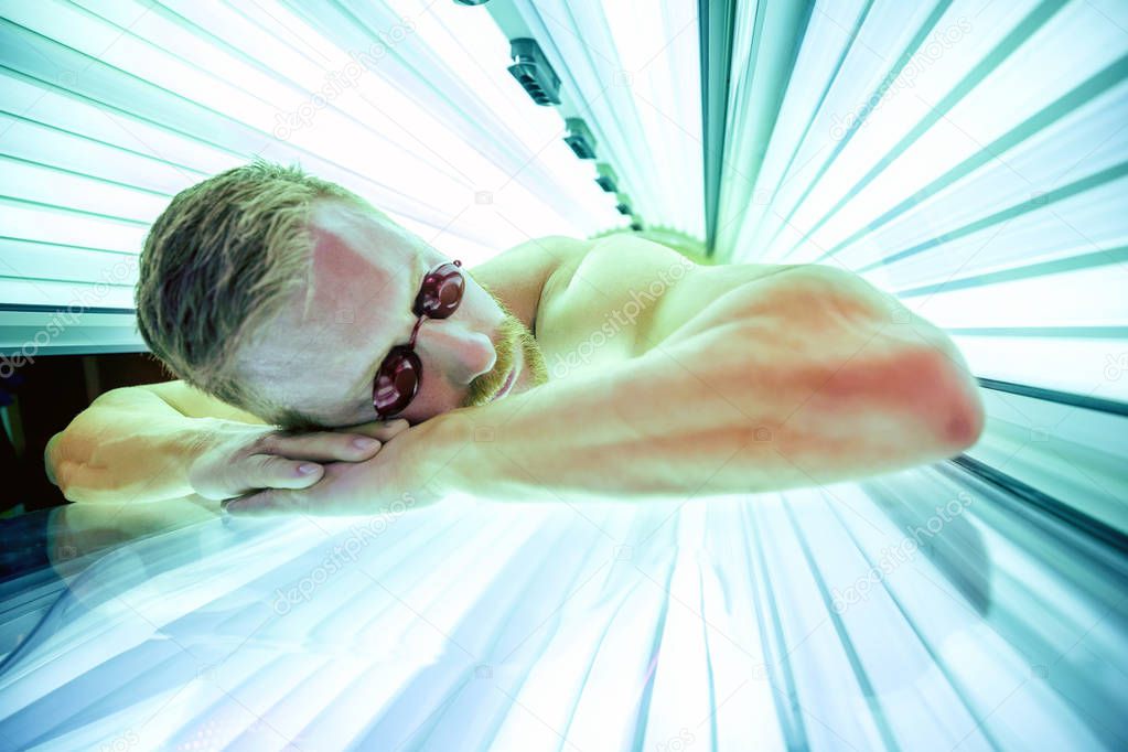 Pretty young man in solarium 