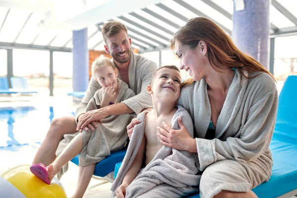 Mamma pappa och deras barn värmer upp efter simning — Stockfoto