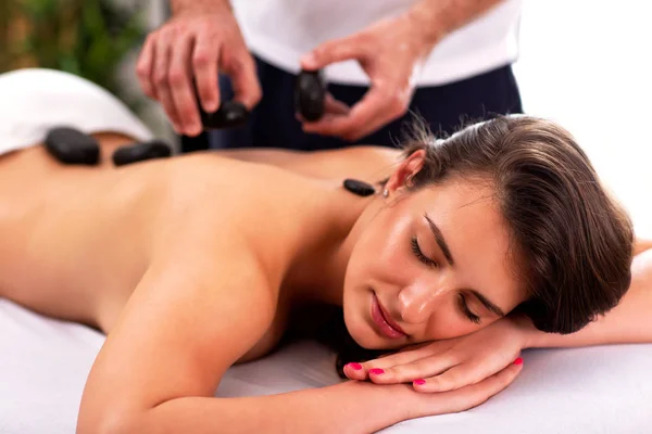 Hübsche Mädchen mit einem Stein Massage-Therapie — Stockfoto