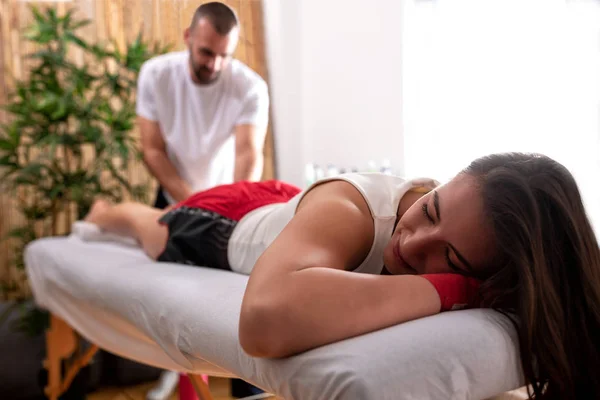 Young kick boxer girl having a post workout massage — Stock Photo, Image
