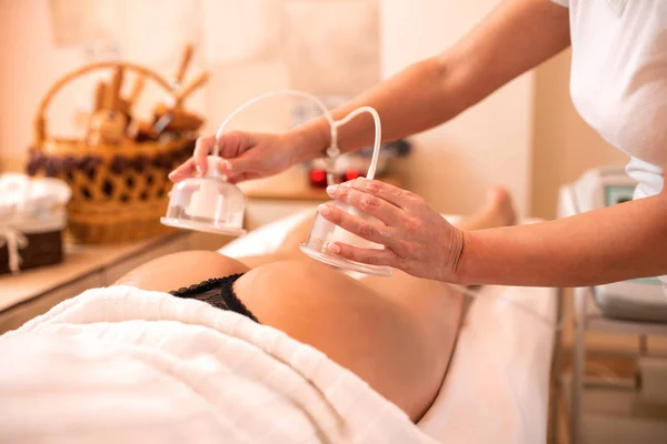 Masseuse holding anti-cellulite silicone suction cups — Stock Photo, Image