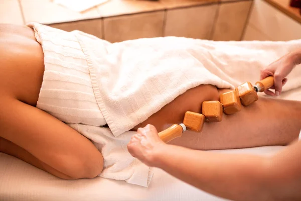 Антицелюлітний масаж спеціальним дерев'яним валиком — стокове фото