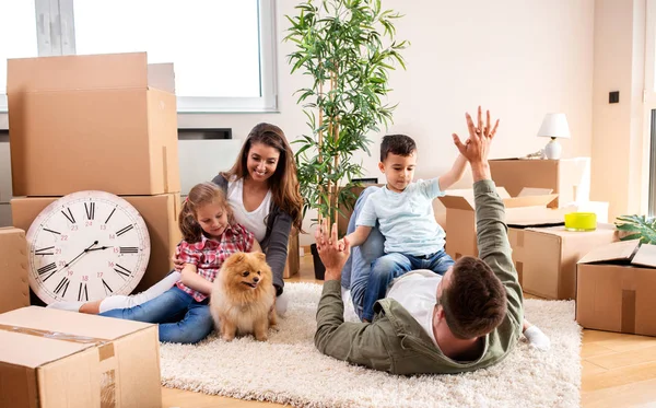 Mama, Papa, ihre Kinder und ihr Hund ziehen in die neue Wohnung ein — Stockfoto