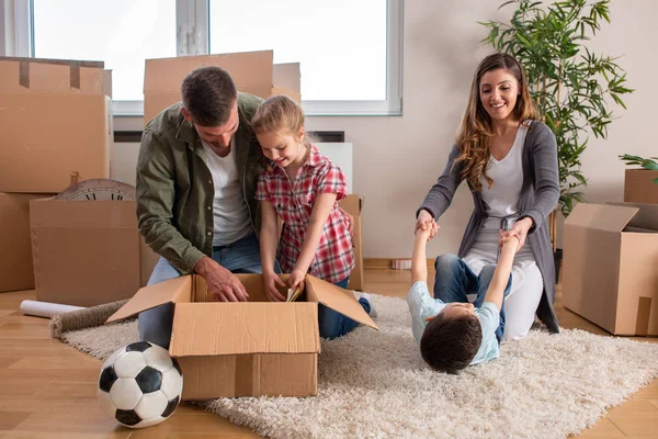 Junges Paar zieht mit seinen Kindern in ein neues Zuhause — Stockfoto