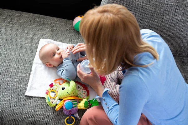 Loving Mom Giving Her Baby Some Water Sit Lay Sofa — Stok Foto