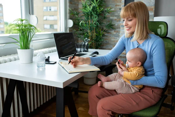 Loving Mom Taking Notes She Works Holding Baby Same Time — Stok Foto