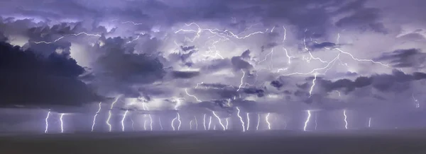 Heavy thunder storm with plenty of strikes over the sea — Stock Photo, Image