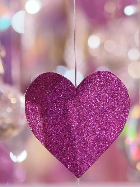 purple heart made from shining paper hanging on blur background symbol love Valentine Day