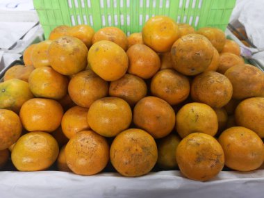 turuncu meyve yeşil plastik sepet